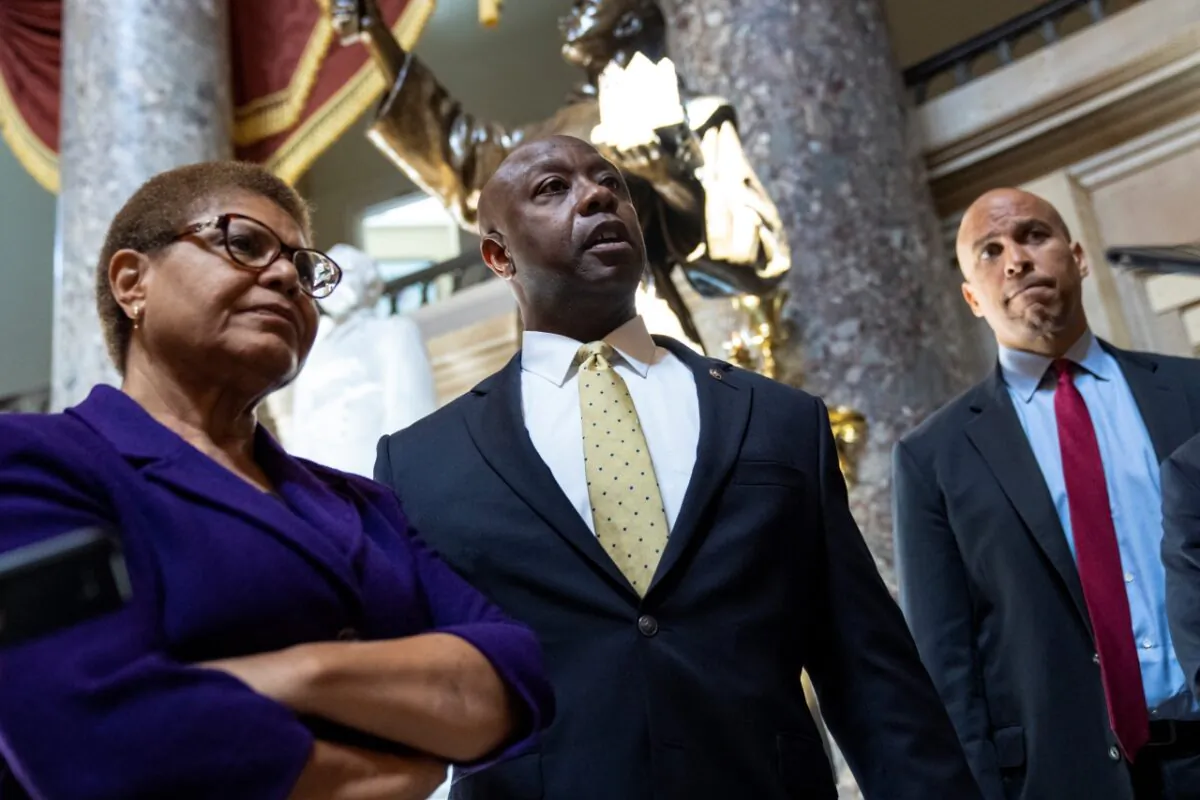 (L-R) Rep. Karen Bass (D-Calif.), Sen. Tim Scott (R-S.C.), and Sen. Cory Booker (D-N.J.) speak briefly to reporters as they exit the office of Rep. James Clyburn (D-S.C.) following a meeting about police reform legislation on Capitol Hill in Washington on May 18, 2021. (Drew Angerer/Getty Images)
