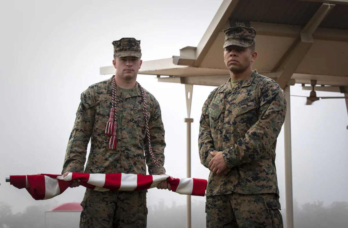 United States Marines (left) Lance Corporal Brandon James and Lance Corporal Devyn Dockery prepare to raise the national flag of the United States of America before the start of the opening ceremony of Exercise Southern Jackaroo 21 at 1st Brigade headquarters, Darwin on June 15. (PTE Jacob Joseph/ADF)