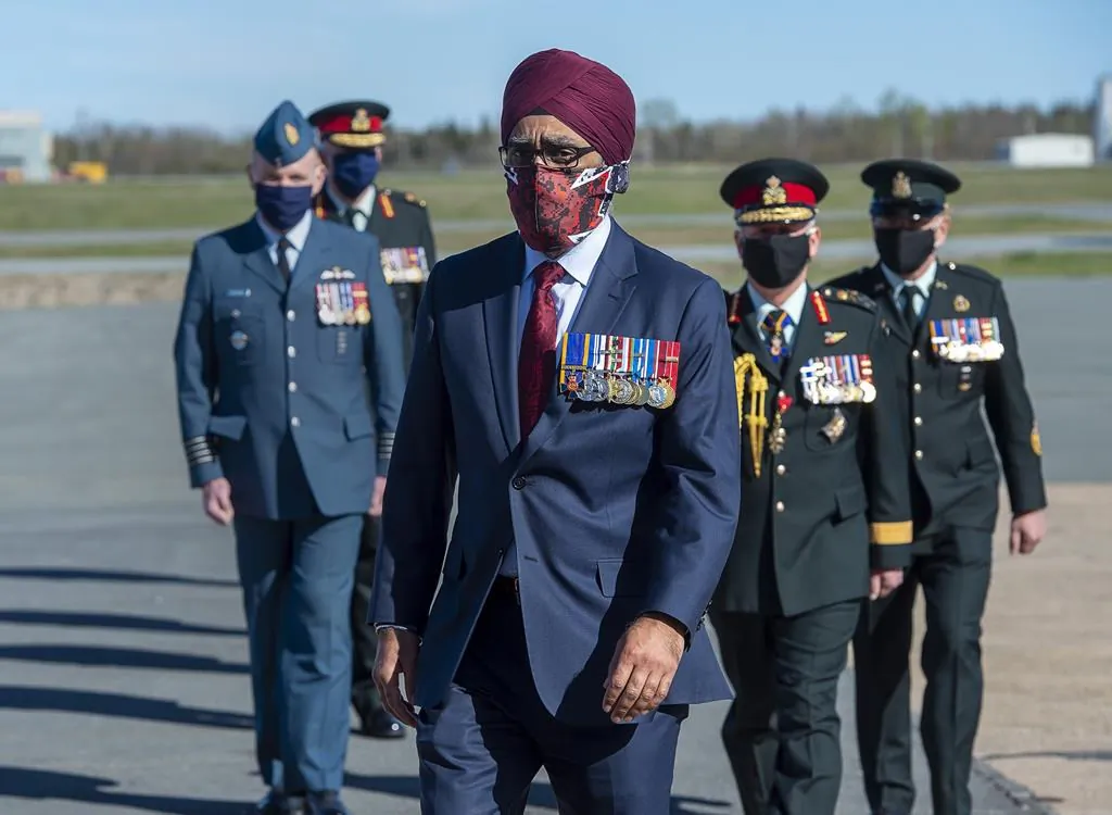 Defence Minister Harjit Sajjan is followed by Canadian Forces officers at a homecoming ceremony at Halifax Stanfield International Airport in Enfield, N.S., on May 24, 2020. (The Canadian Press/Andrew Vaughan)