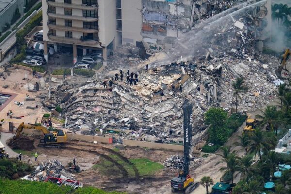 Rescue workers work in the rubble