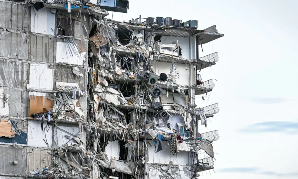 Rubble hangs from a partially collapsed building in Surfside north of Miami Beach, Fla., on June 24, 2021. (Chandan Khanna/AFP via Getty Images)