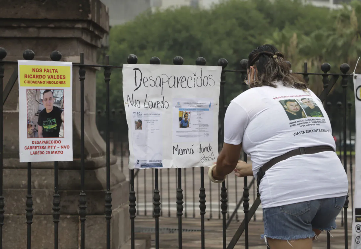 Family of Ricardo Valdes, who disappeared on the road on May 25, placed missing posters during a protest in Monterrey, Nuevo Leon state, Mexico, on June 24, 2021. (Roberto Martinez/AP Photo)