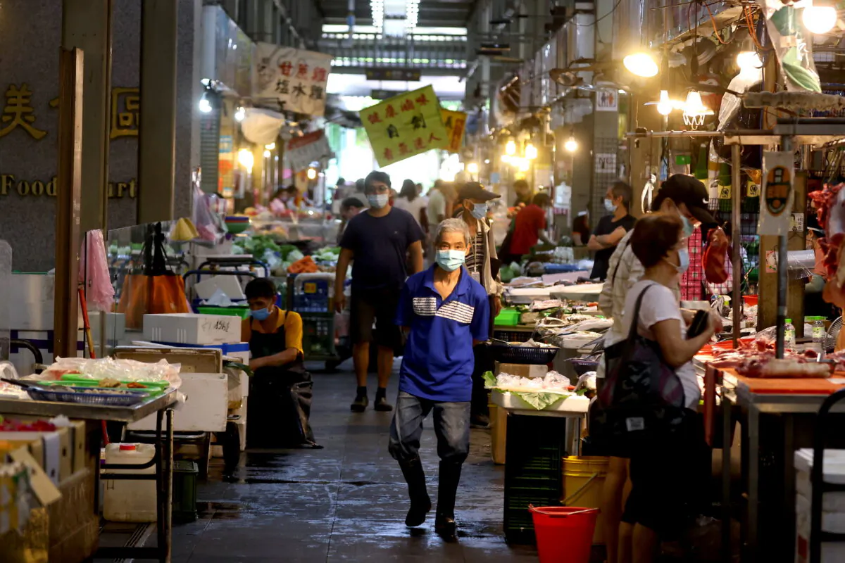 People wearing protective face masks shop at a market amid the coronavirus pandemic, in Taipei, Taiwan, on June 8, 2021. (Ann Wang/File/Reuters)