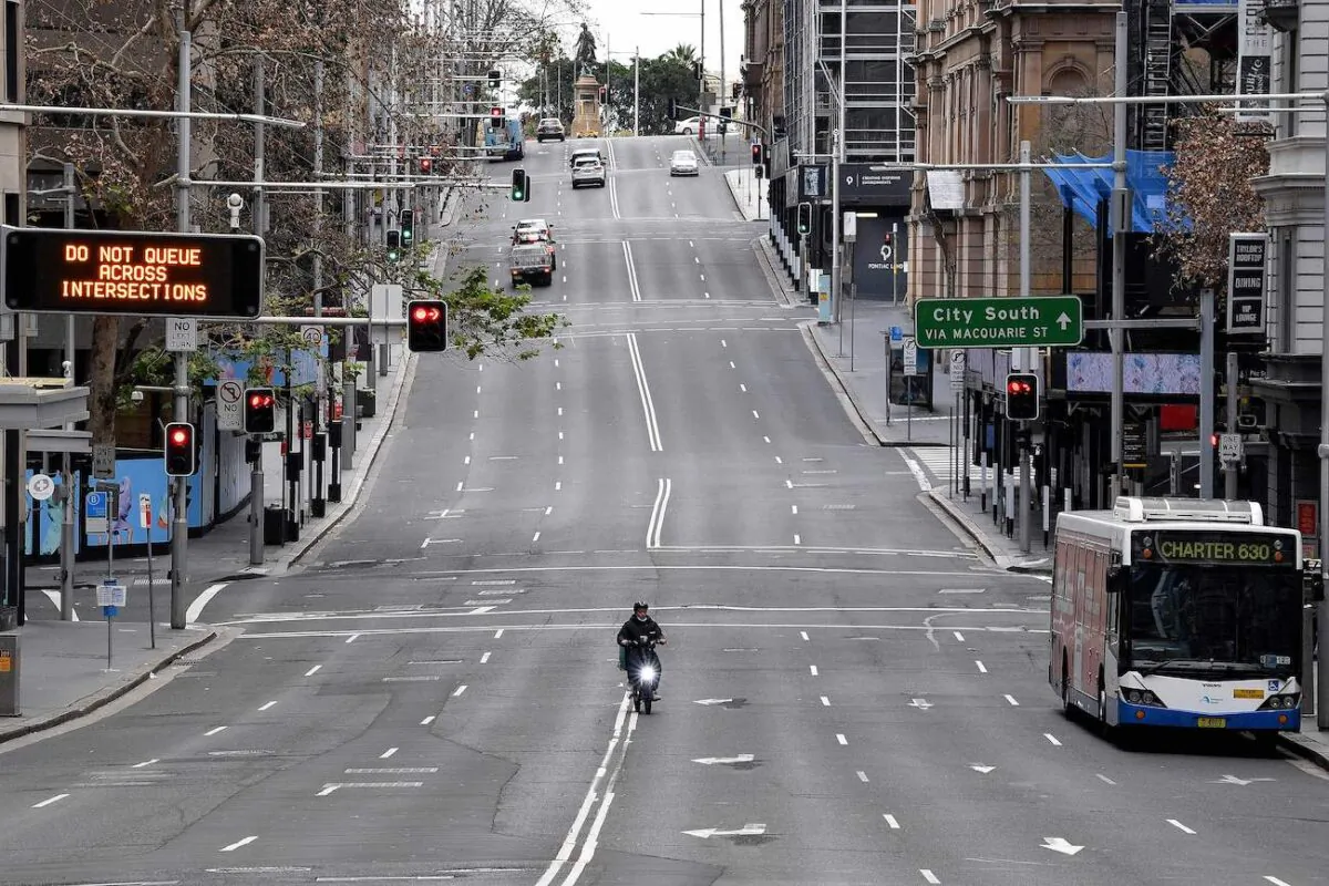 A food delivery worker rides in the central business district of Sydney on June 26, 2021. (Saeed Khan/AFP via Getty Images)