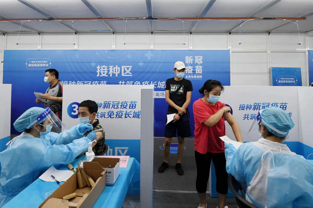 Residents receive vaccines against COVID-19 at a makeshift vaccination site in Guangzhou, Guangdong Province, China, on June 21, 2021. (Cnsphoto via Reuters)