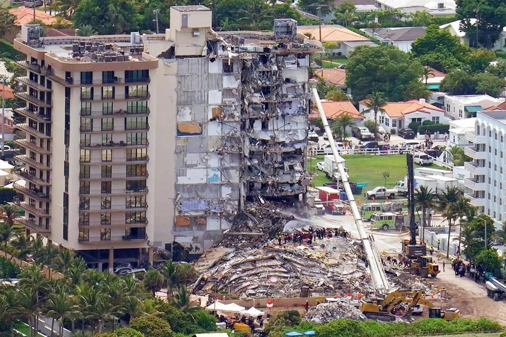 Workers search in the rubble at the Champlain Towers South Condo, on June 26, 2021, in Surfside, Fla. One hundred fifty-nine people were still unaccounted for two days after Thursday's collapse, which killed at least four. (AP Photo/Gerald Herbert)