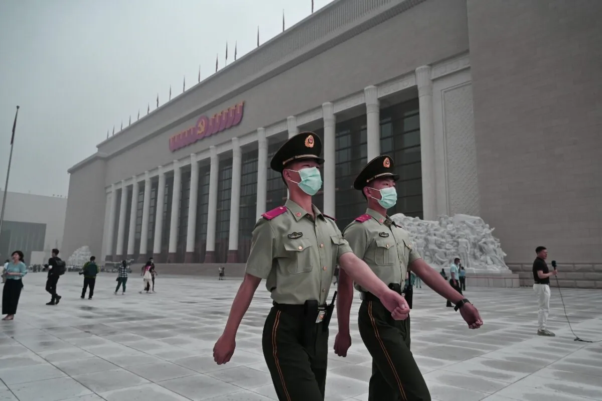 Chinese police officers walk outside the newly built Museum of the Communist Party of China in Beijing on June 25, 2021. (Kevin Frayer/Getty Images)