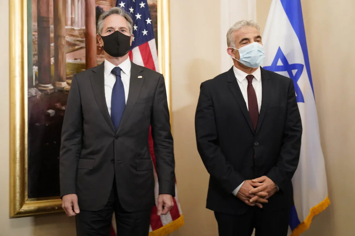 Secretary of State Antony Blinken (L) and Israeli Foreign Minister Yair Lapid pose for a family picture during their meeting in Rome, on June 27, 2021. (Andrew Harnik/Pool/AP Photo)