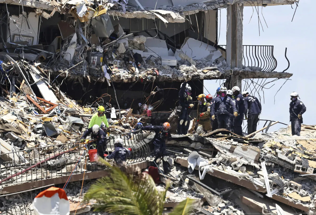 Search and rescue personnel look for survivors through the rubble at the Champlain Towers South in Surfside, Fla., on June 27, 2021. (David Santiago/Miami Herald via AP)