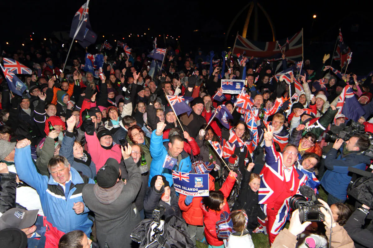 Islanders celebrate after the annouce of the referendum's result in Port Stanley, Falkland (Malvinas for Argentina) Islands, on March 11, 2013. Falkland Islanders were to vote  on the final day of a two-day referendum designed to make clear their staunch desire to remain British despite Argentina's sovereignty claims. Only three votes out of 1,517 were cast against the islands remaining British. (Tony Chater/AFP via Getty Images)