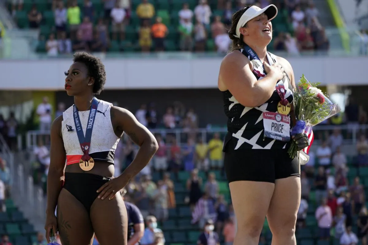 Gwendolyn Berry (L), looks away as DeAnna Price stands for the national anthem after the finals of the women's hammer throw at the U.S. Olympic Track and Field Trials in Eugene, Ore., on June 26, 2021. (Charlie Riedel/AP Photo)