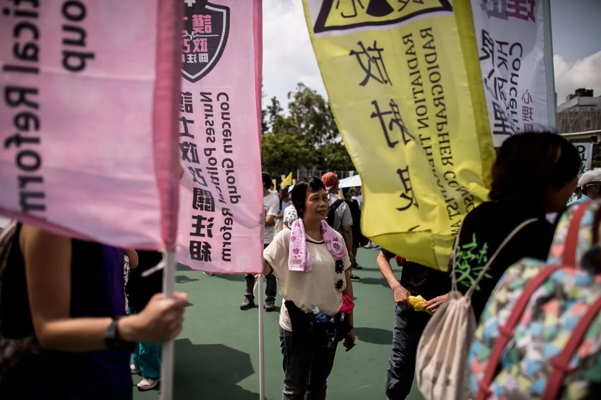 A protester holds a flag ahead of the pro-democracy march in Hong Kong on July 1, 2015. (Anthony Kwan/Getty Images)