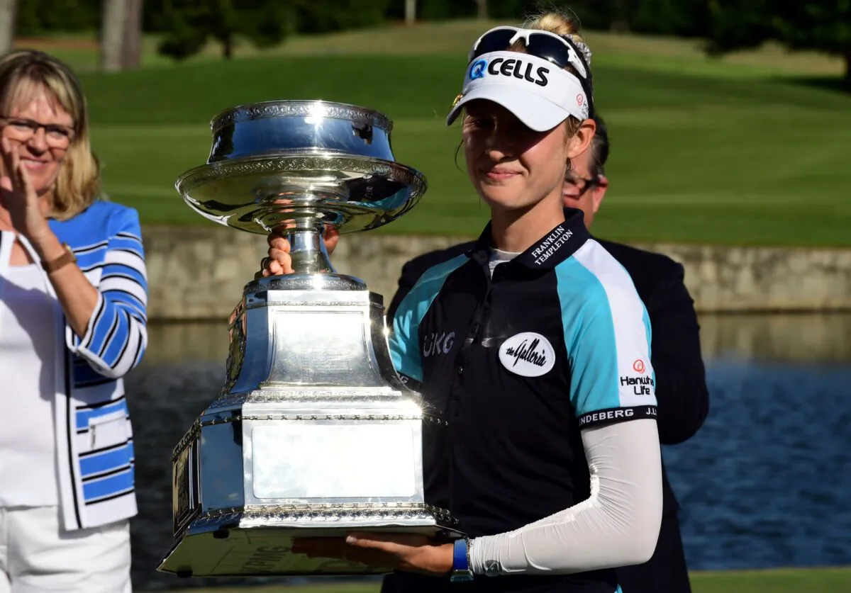 Nelly Korda holds the championship trophy as she celebrates winning the KPMG Women's PGA Championship golf tournament at the Atlanta Athletic Club in John's Creek, Ga., on June 27, 2021. (Adam Hagy/USA TODAY Sports)