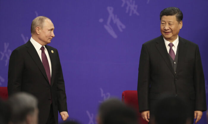 Russian President Vladimir Putin (L) and Chinese leader Xi Jinping (R) attend the Tsinghua University's ceremony at Friendship Palace in Beijing on April 26, 2019. (Kenzaburo Fukuhara/Pool/Getty Images)