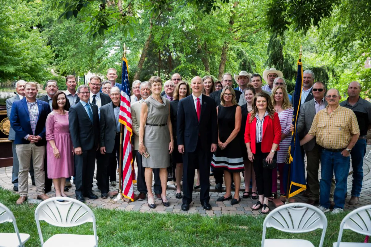 Nebraska Gov. Pete Ricketts (C) with supporters in front of his residence in Lincoln, Neb., on June 24, 2021, after signing an executive order against the Biden administration's plan to have 30 percent of American land and waters in conservation by 2030. (Petr Svab/The Epoch Times)