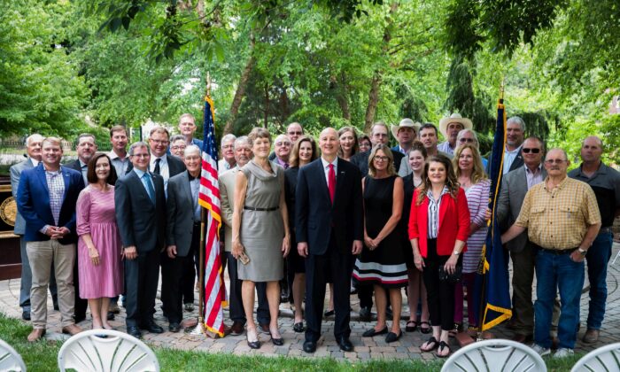 Nebraska Gov. Pete Ricketts (C) with supporters in front of his residence in Lincoln, Neb., on June 24, 2021, after signing an executive order against the Biden administration's plan to have 30 percent of American land and waters in conservation by 2030. (Petr Svab/The Epoch Times)