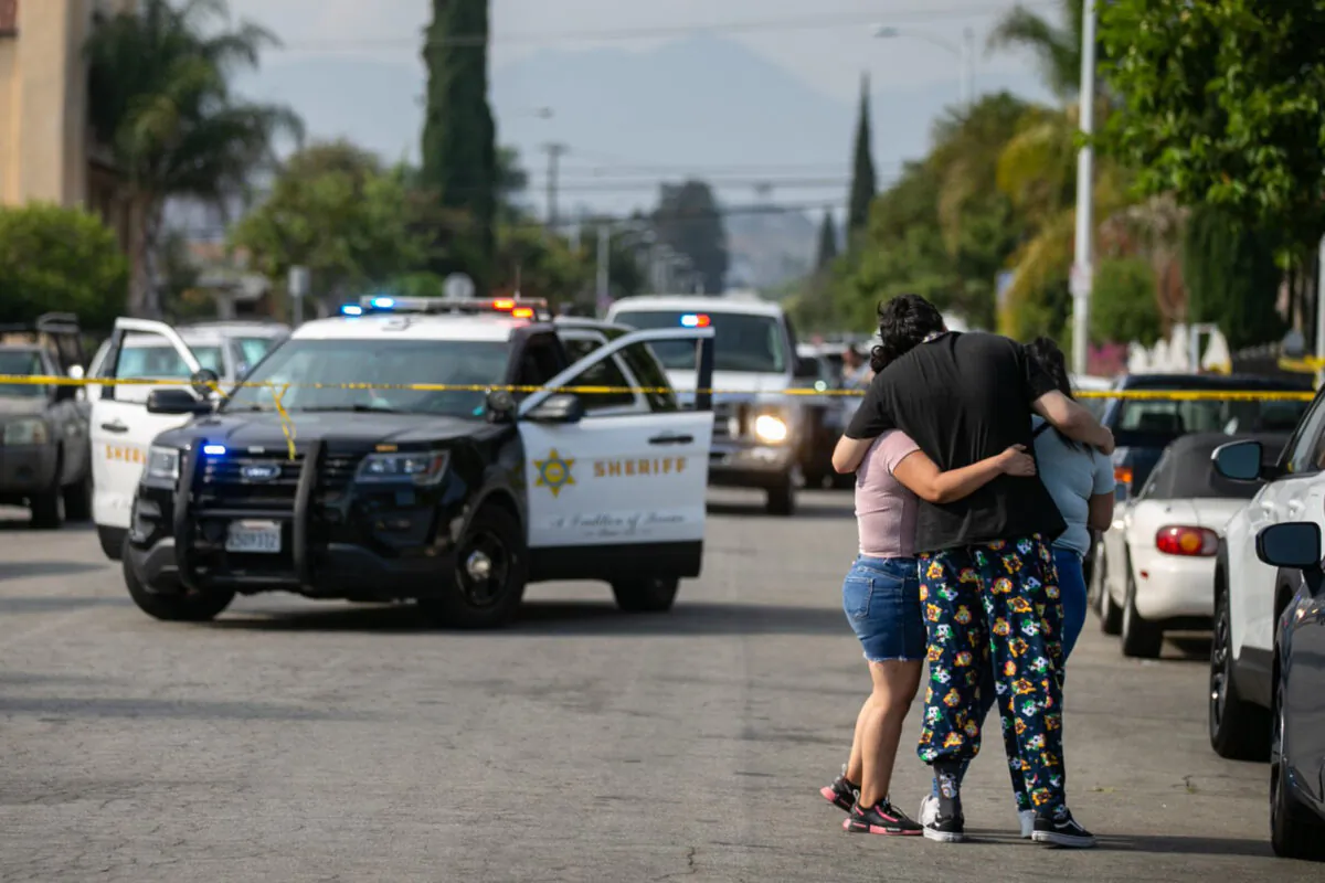 Neighbors embrace and the come to grips with three children being found dead at a home on South Ferris Ave in East Los Angeles, Calif., on June 28, 2021. (Jason Armond/Los Angeles Times/TNS)