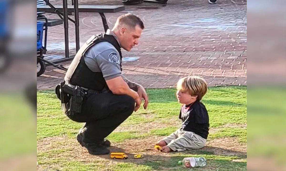 Officer Rolf Seiferheld of the Duluth Police Department talking to Harrison Humphries, 6, during the Food Truck Friday event in downtown Duluth on May 21. (Courtesy of Duluth Police Department)