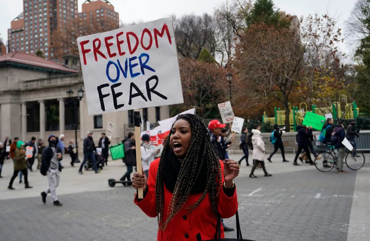 A protester holds a sign during an anti-lockdown protest in New York on Nov. 22, 2020. (Timothy A. Clary/AFP/Getty Images)