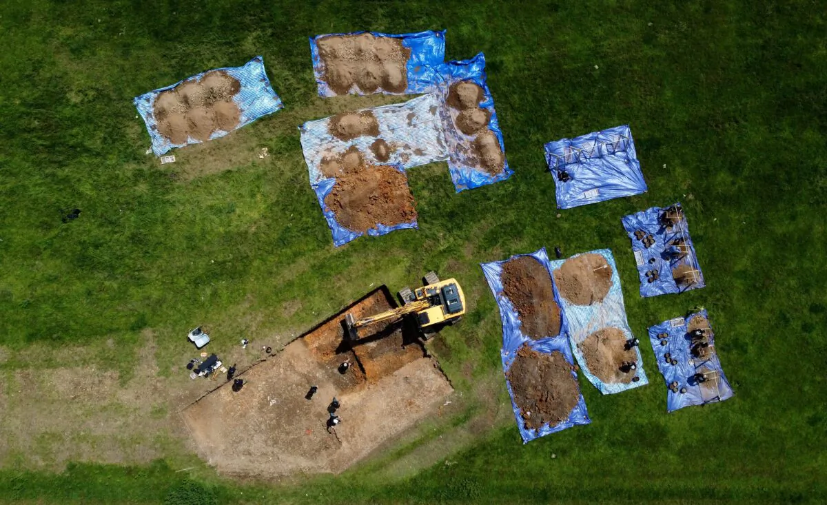 Archaeologists and American Defense POW/MIA Accounting Agency staff work to recover the remains of an American bomber crew, whose aircraft crashed at a site in Arundel in 1944, in Sussex, UK, on June 28, 2021. (Gareth Fuller/PA)
