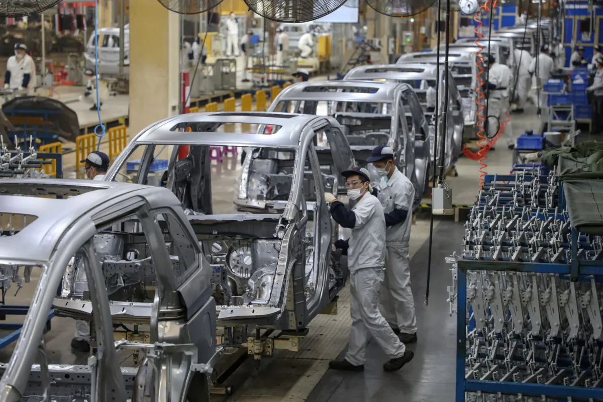 Employees working on an assembly line at an Dongfeng Honda auto in Wuhan in China's central Hubei Province, on April 15, 2021. (STR/AFP via Getty Images)