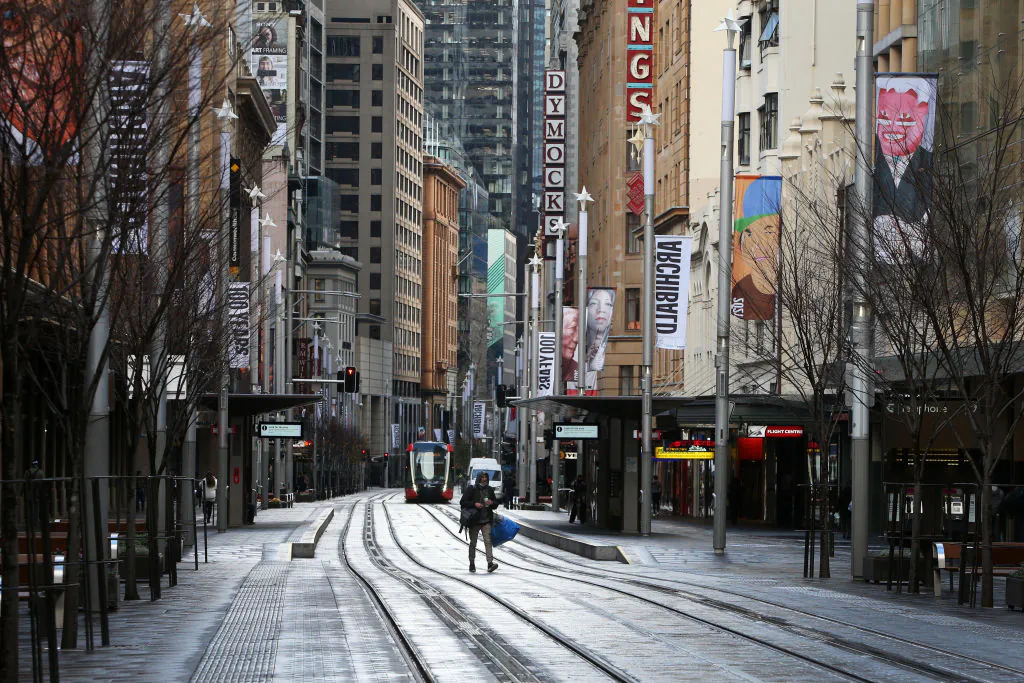 A pedestrian moves along an almost empty George Street in the Sydney CBD, Australia on June 28, 2021. (Lisa Maree Williams/Getty Images)
