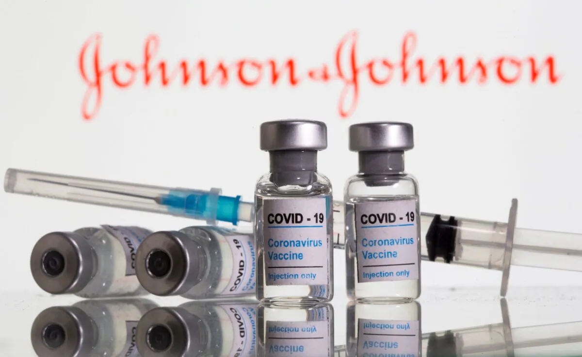 Vials labelled "COVID-19 Coronavirus Vaccine" and sryinge in front of the Johnson&Johnson logo in this illustration taken, on Feb. 9, 2021. (Dado Ruvic/Reuters)