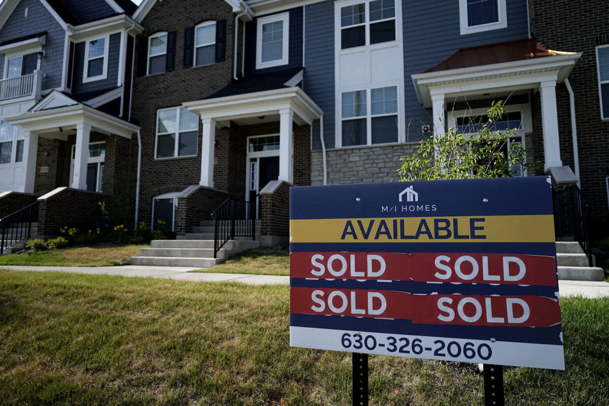 An advertising sign for building land stands in front of a new home construction site in Northbrook, Ill., on June 23, 2021. (Nam Y. Huh/ AP Photo)