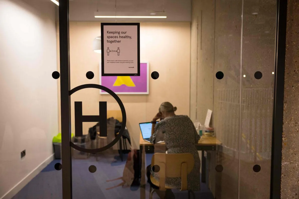 A woman works in a meeting room at the WeWork, in London, on April 13, 2021. (Tolga Akmen/AFP via Getty Images)