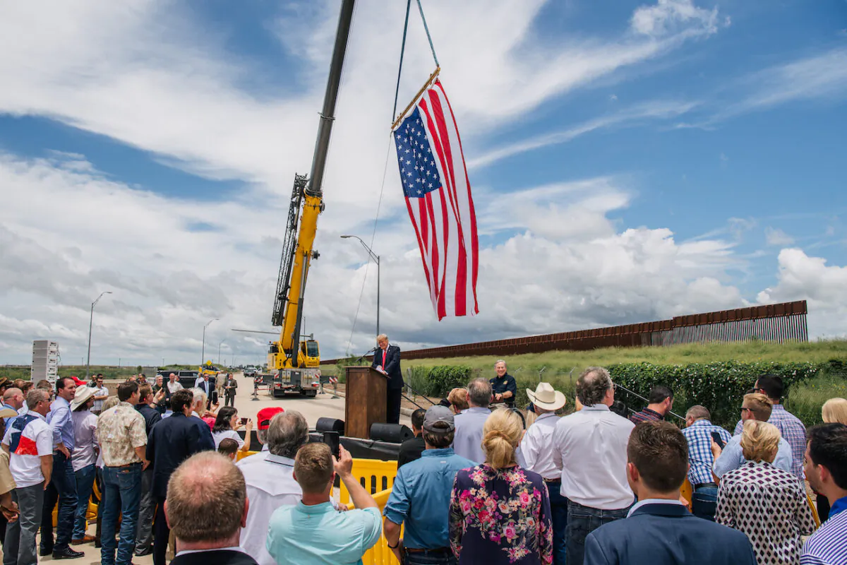 People listen to former President Donald Trump's address during a tour to an unfinished section of the border wall in Pharr, Texas, on June 30, 2021. (Brandon Bell/Getty Images)