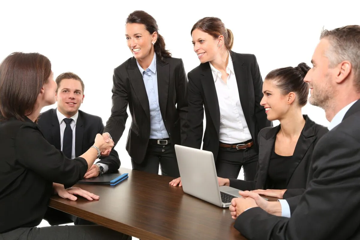 People shake hands during a work meeting in a stock photo. (Pixabay)