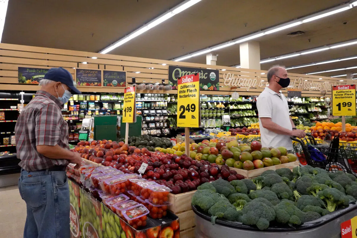 Customers shop for produce at a supermarket in Chicago, Illinois, on June 10, 2021. (Scott Olson/Getty Images)