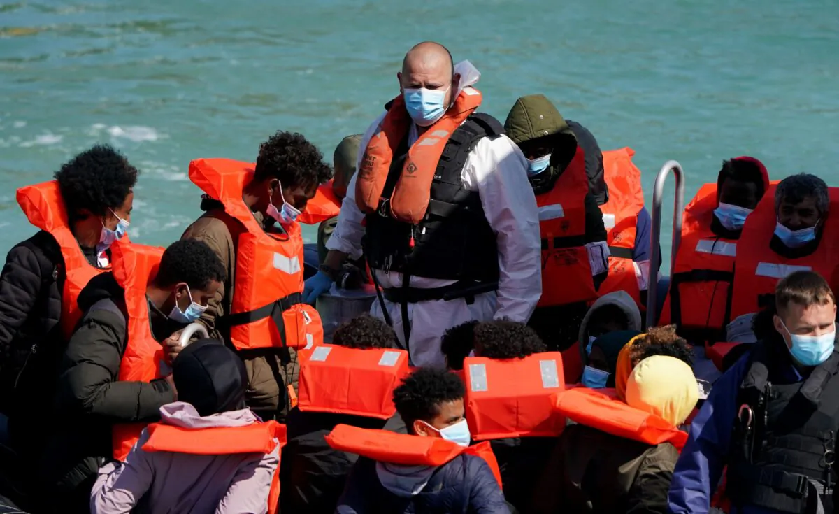 People thought to be illegal immigrants are brought into Dover, Kent, following a small boat incident in the Channel on July 1, 2021. (Gareth Fuller/PA)
