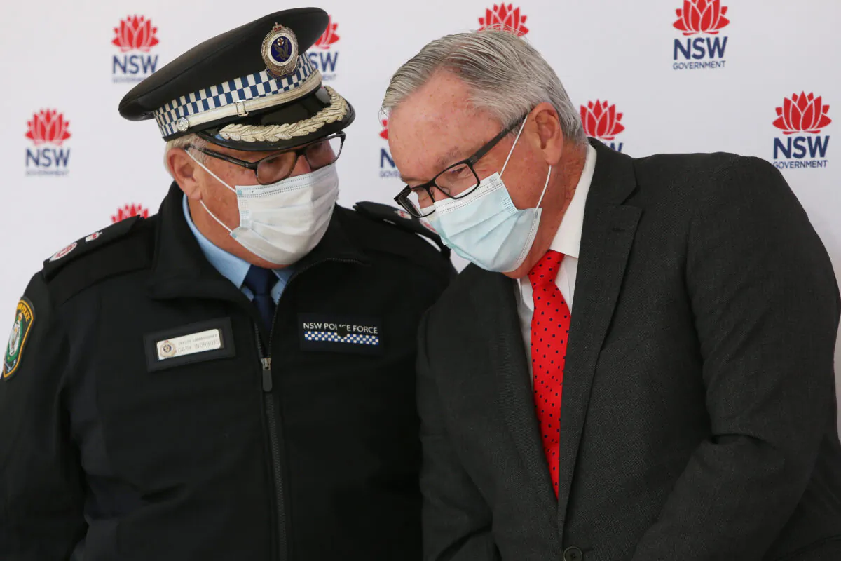 NSW Police Deputy Commissioner Gary Worboys speaks with NSW Minister for Health and Medical Research Brad Hazzard during a press conference in Sydney, Australia, on July 16, 2021. (Lisa Maree Williams/Getty Images)