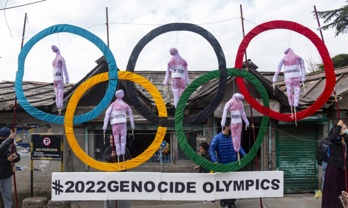 Exiled Tibetans use the Olympic Rings as a prop as they hold a street protest against the holding of 2022 Winter Olympics in Beijing in Dharmsala, India, on Feb. 3, 2021. (Ashwini Bhatia, File/AP Photo)
