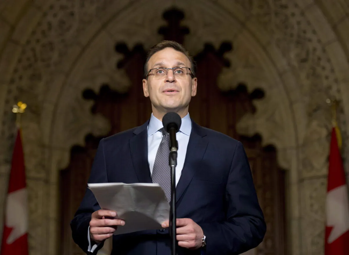 Sen. Leo Housakos speaks with the media in the Senate foyer on Parliament Hill in Ottawa in a file photo. (The Canadian Press/Adrian Wyld)