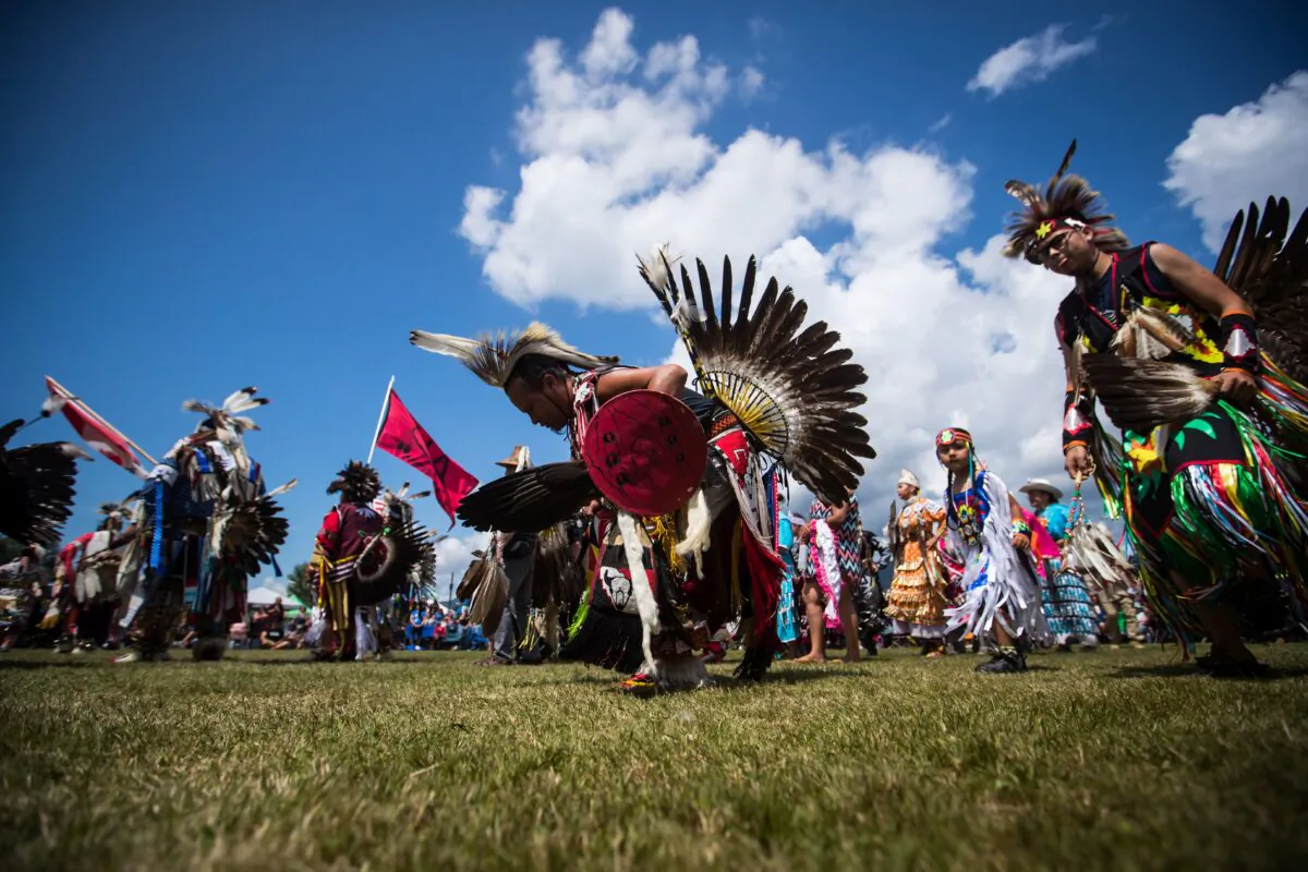 First Nations dancers participate in the grand entry on the final day of the 32nd annual Squamish Nation Youth Powwow, in West Vancouver on July 14, 2019. (The Canadian Press/Darryl Dyck)