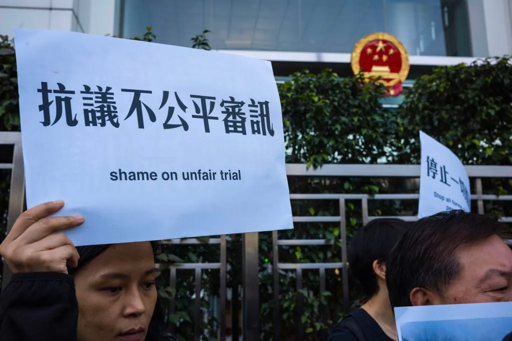Activists hold placards in support of detained Chinese human rights lawyer at a rally outside the Chinese Liaison Office in Hong Kong on Dec. 26, 2018. (Anthony Wallace/AFP via Getty Images)