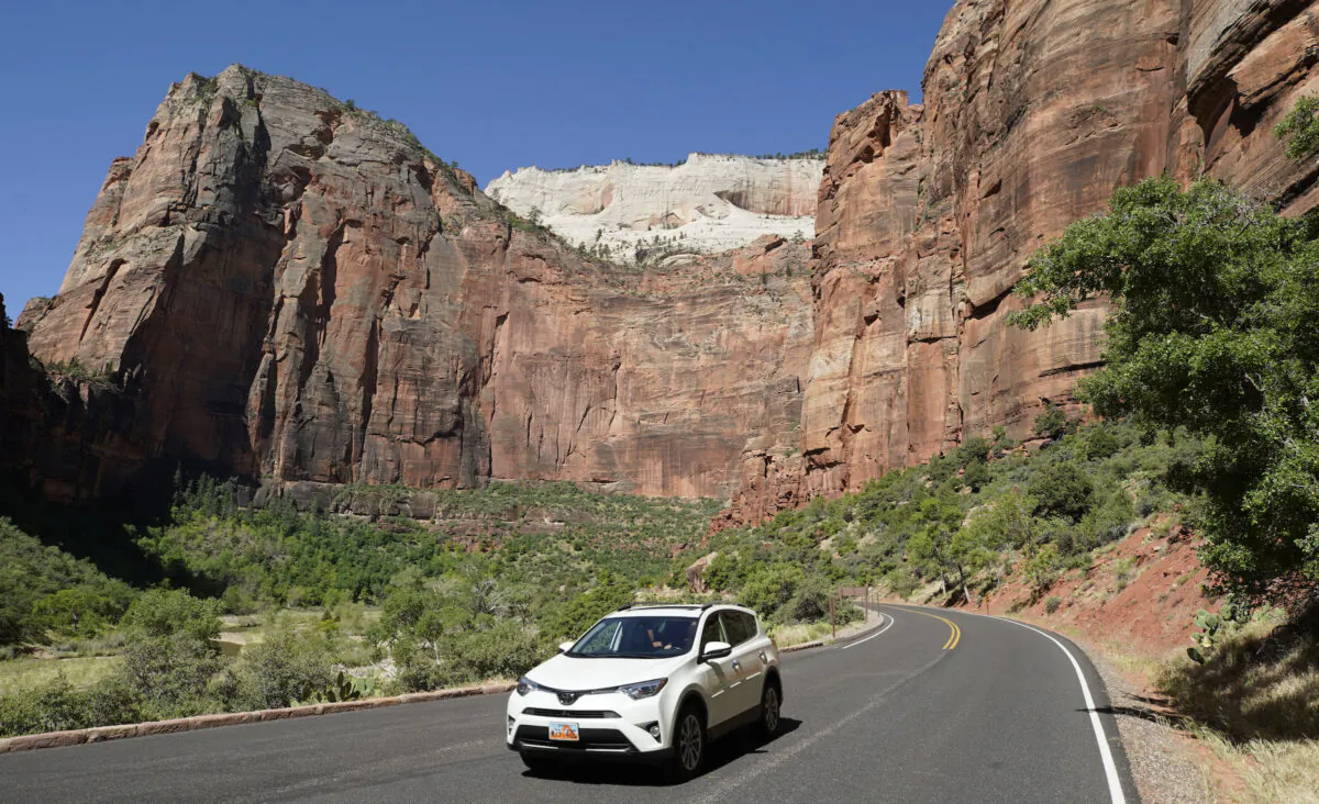 A lone car makes its way down a road in Zion National Park in Springdale, Utah, on May 15, 2020. (George Frey/Getty Images)