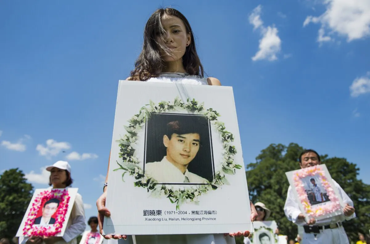 Falun Gong practitioners hold memorial pictures as they march on Capitol Hill in Washington, on July 17, 2014. (Jim Watson/AFP/Getty Images)
