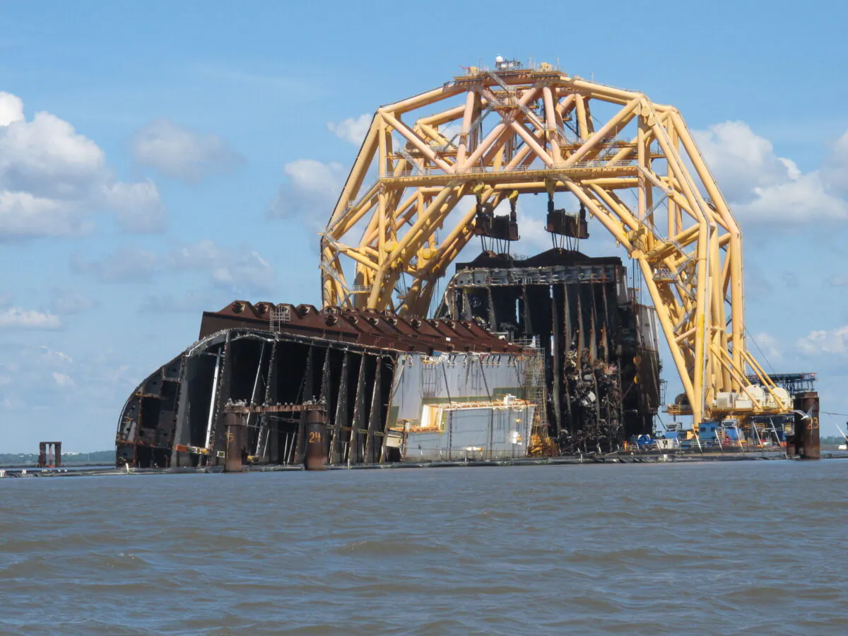 A towering crane pulls the engine room section away from the remains of the capsized cargo ship Golden Ray, offshore of St. Simons Island, Ga. on April 26, 2021. (Russ Bynum/AP Photo)