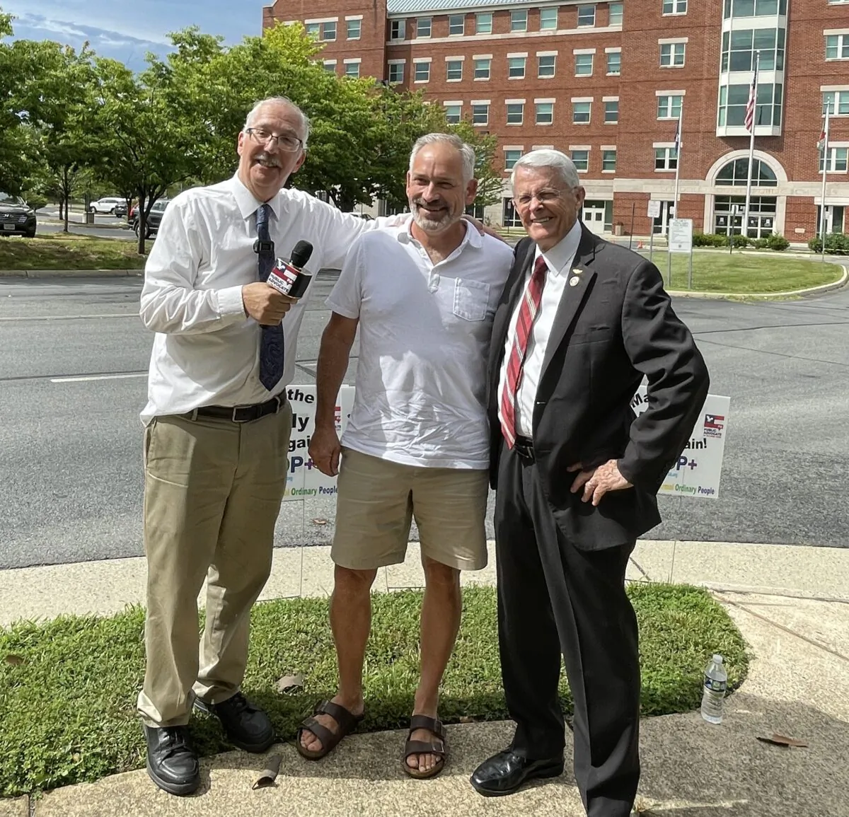 Former state senator Dick Black (right) with Eugene Delgaudio (left), president of Public Advocates, and Jon Tigges (center) outside the Loudoun County Public School administration building on July 1. (Terri Wu/The Epoch Times)