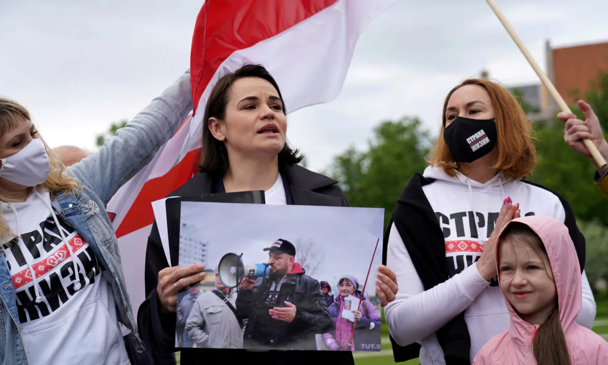 Belarus opposition leader Sviatlana Tsikhanouskaya holds a picture of her husband Syarhei Tsikhanouski during a "Belarus support day" protest in Vilnius, Lithuania, on May 29, 2021. (Janis Laizans/Reuters)