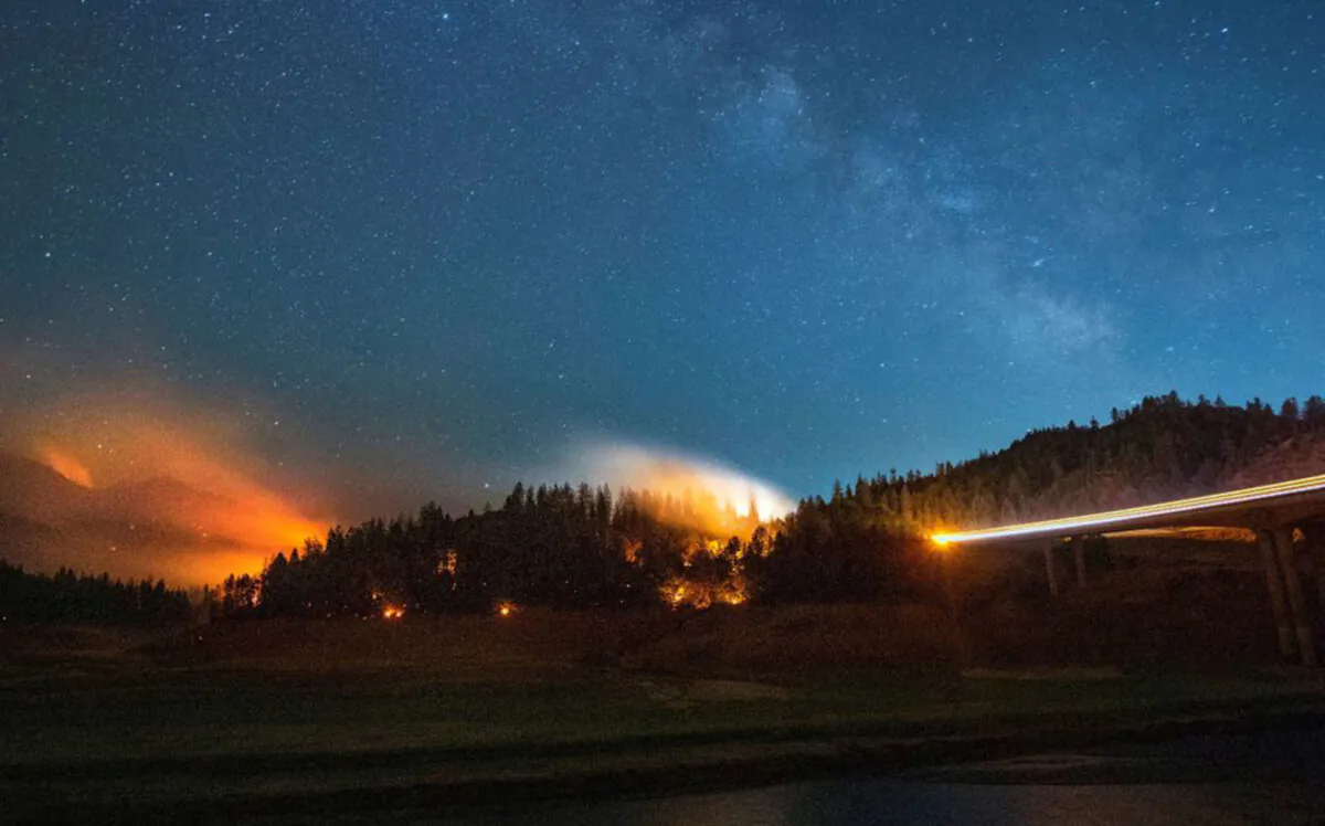 Flames surround a drought-stricken Shasta Lake during the "Salt fire" in Lakehead, Calif., early on July 2, 2021. (Josh Edelson/AFP via Getty Images)