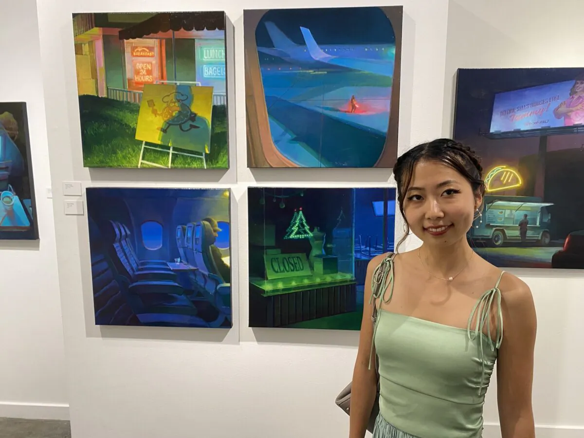 Renae Wang, an MFA graduate at Laguna College of Art and Design, said her paintings are based in non-places, or public and transient spaces and feature an “underlying solitude,” with characters in her paintings not interacting with each other.  (Jack Bradley/The Epoch Times)