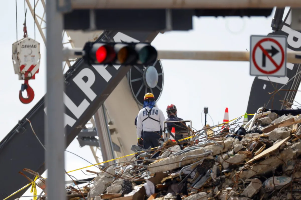 Rescue personnel continue the search and rescue operation for survivors at the site of a partially collapsed residential building in Surfside, Fla., on July 2, 2021. (Marco Bello/Reuters)