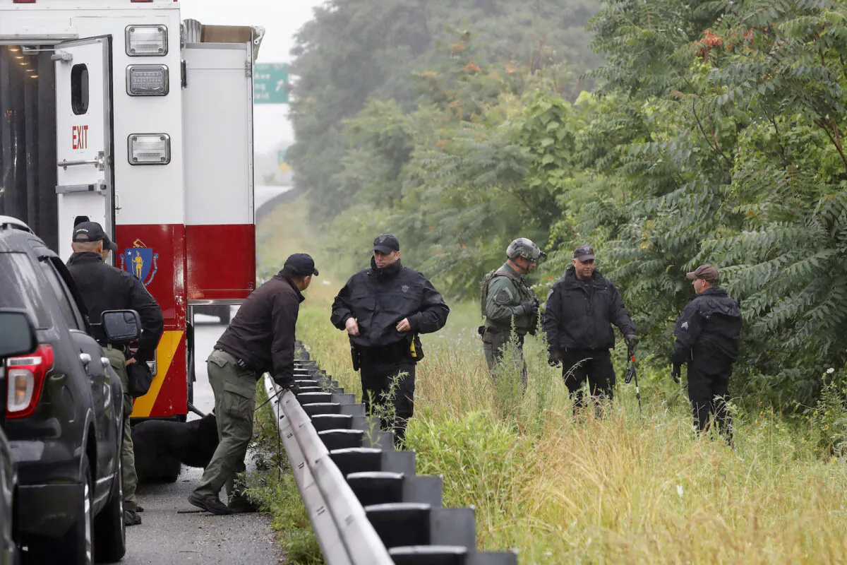 Police work in the area of an hours long standoff with a group of armed men that partially shut down I-95 on July 3, 2021, in Wakefield, Mass. (Michael Dwyer/AP Photo)