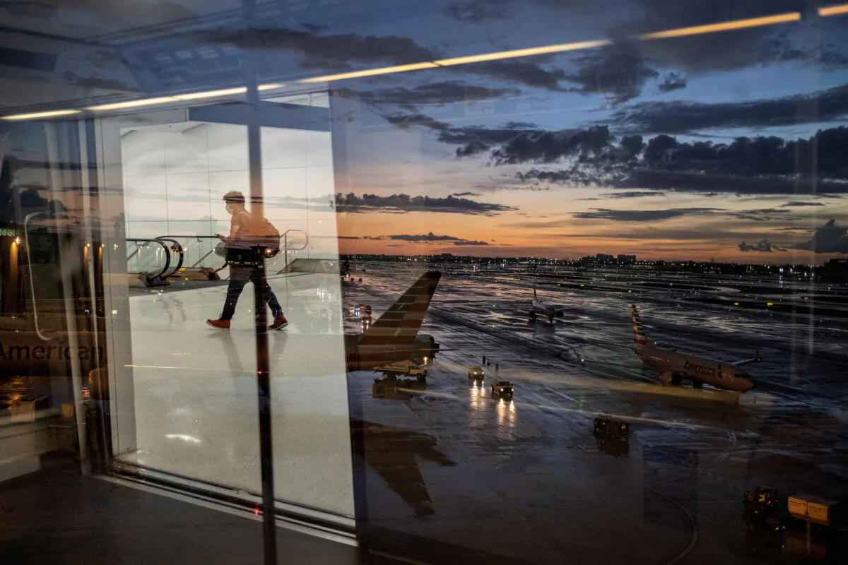 A passenger arrives at terminal D of Miami International Airport after heavy rains, as Hurricane Elsa moves towards south Florida, in Miami, U.S. July 2, 2021. (Carlos Barria/Reuters)