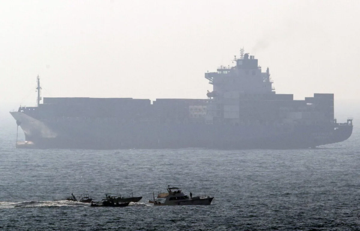 File photo of a cargo ship, the French yacht Dignite/Al Karama enters the Israeli southern port of Ashdod flanked by three small Israeli naval vessels after being intercepted in international waters as it tried to reach Gaza in defiance of Israel's naval blockade on the tiny Palestinian territory on July 19, 2011. (Jack Guez/AFP via Getty Images)