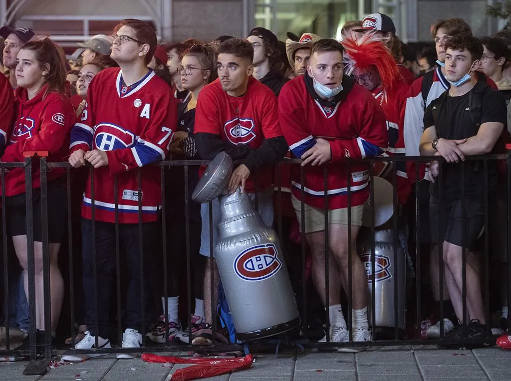 Montreal Canadiens fans look on outside the Bell Centre in Montreal, on July 2, 2021, during game 3 of the NHL Stanley Cup final against the Tampa Bay Lightning. (The Canadian Press/Graham Hughes)